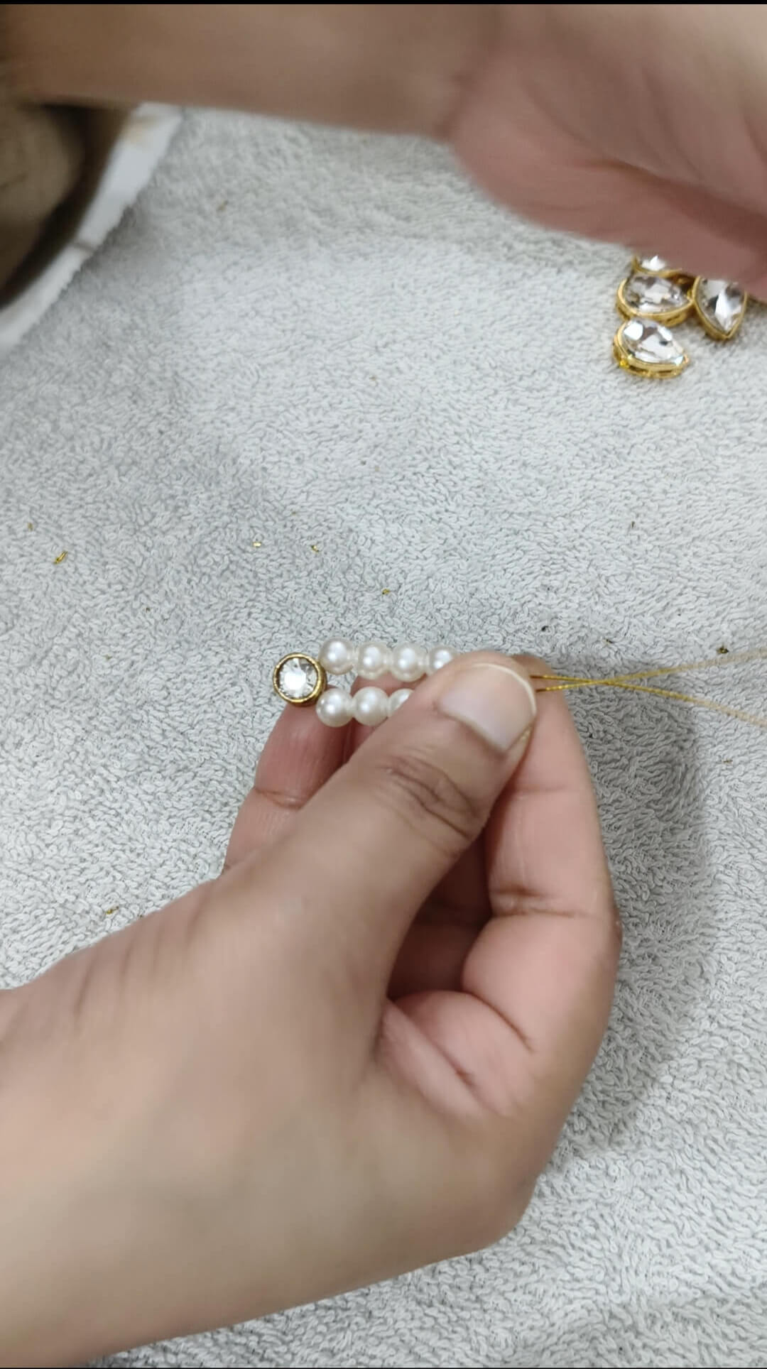Decorating the upper part of pink beads kundan chokar with white pearls